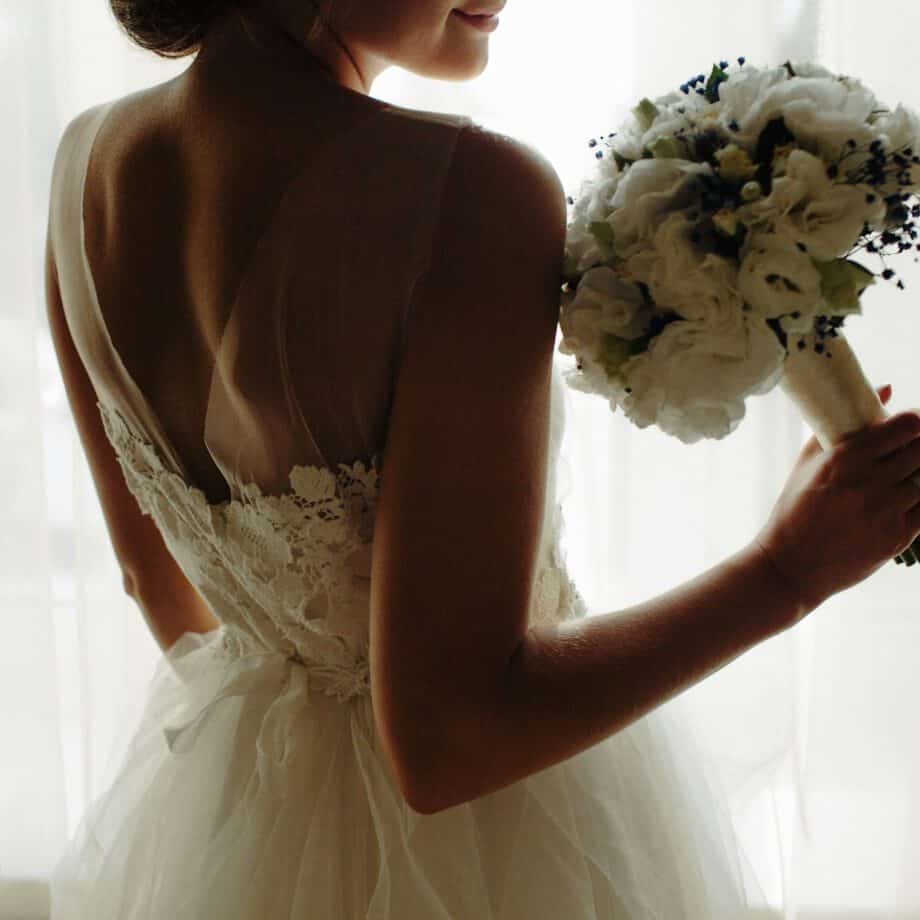 beautiful bride in a wedding dress, by window.